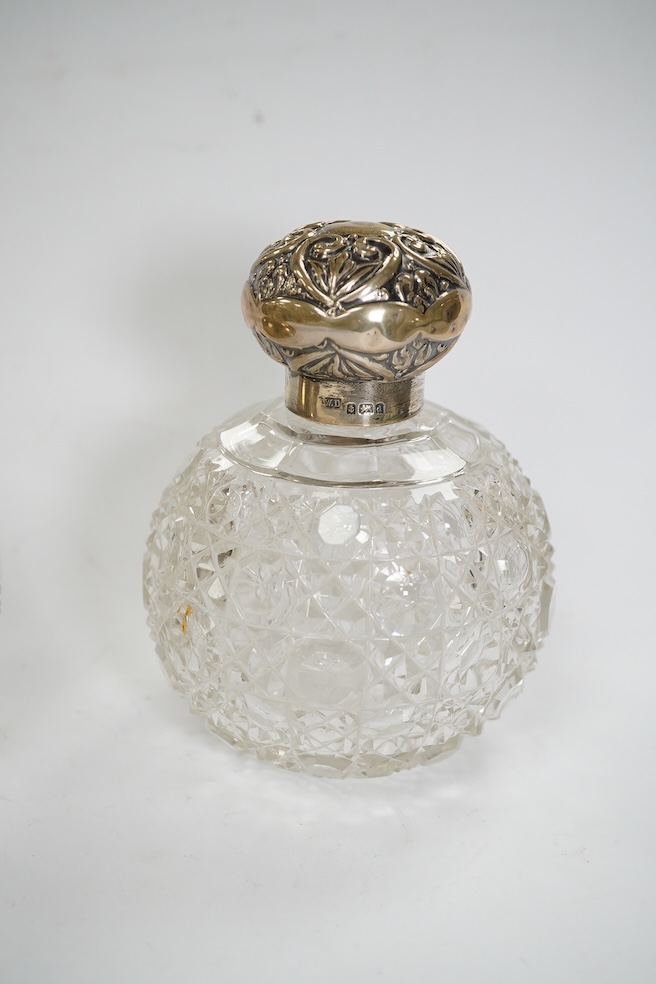 Four assorted mounted glass scent bottles, including three with silver mounts, tallest 11.9cm. Condition - poor